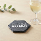 Personalised engraved geometric slate coaster styled with a glass mug on a timber coffee table in Australia.