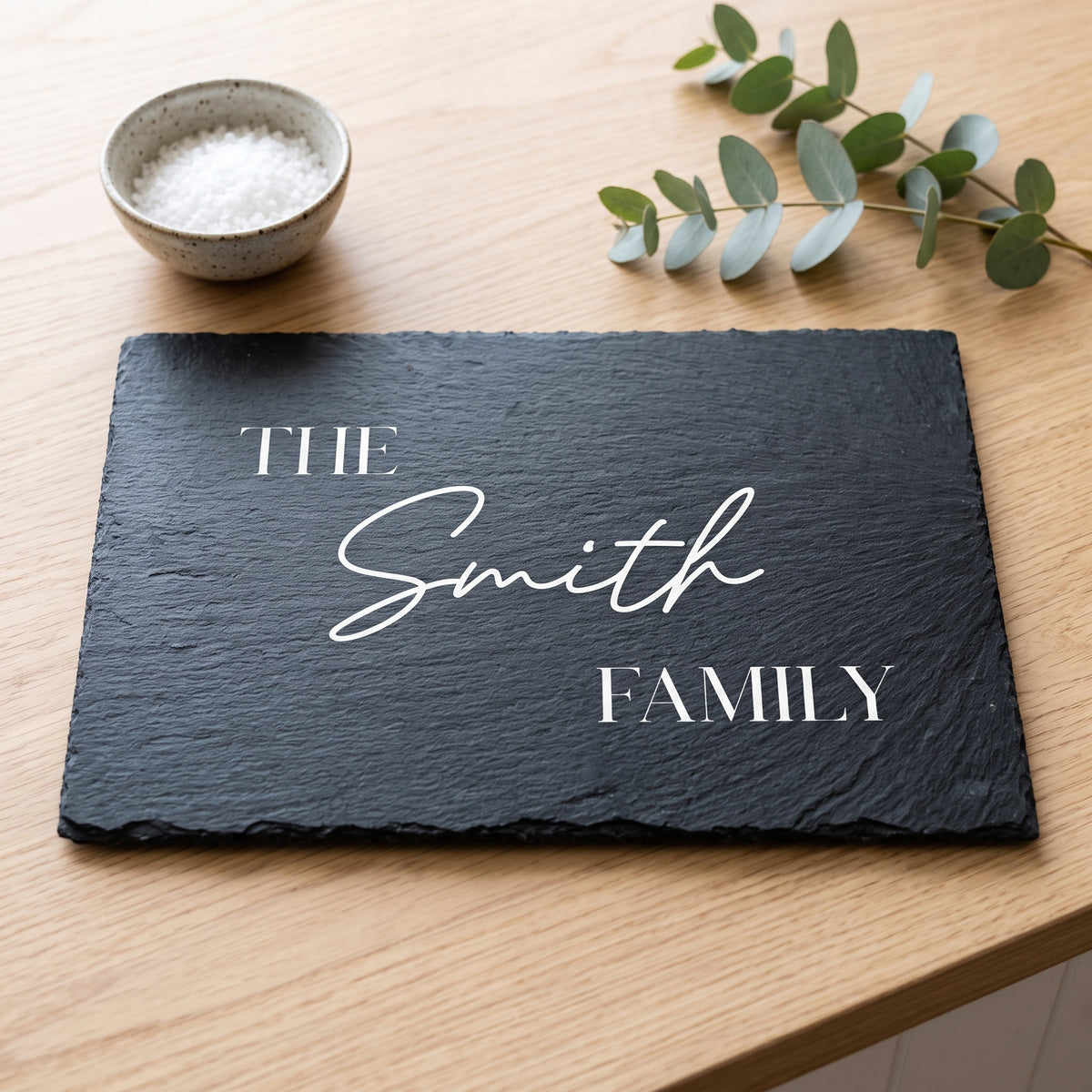 Personalised engraved 30cm x 20cm rectangular slate platter styled with artisanal cheeses and fruit on a table in Australia.
