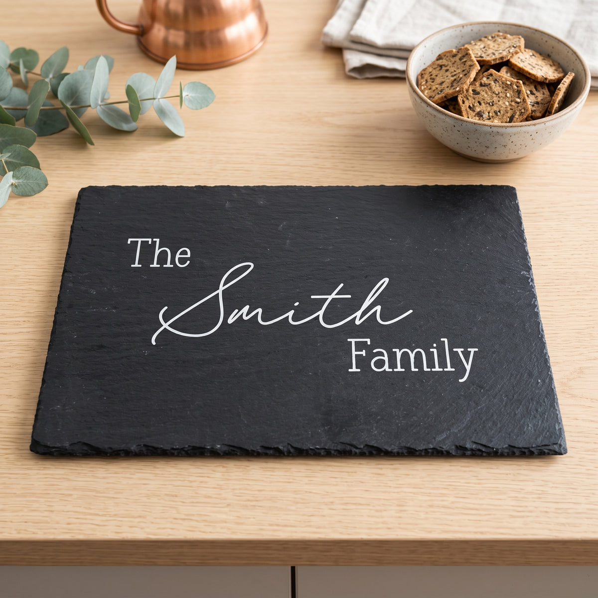 Personalised engraved 30cm x 20cm rectangular slate platter styled with artisanal cheeses and fruit on a table in Australia.