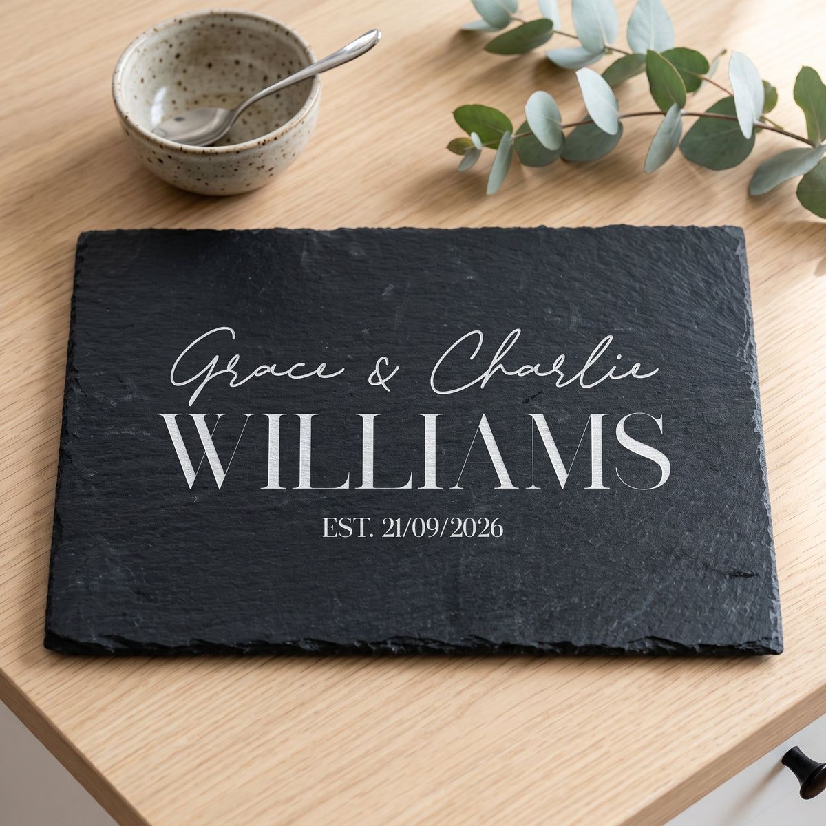 Personalised 30cm x 20cm rectangular slate platter laser engraved in Bespoke Heirloom script layout on dark stone surface.