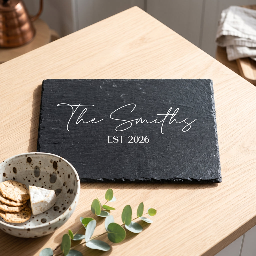 Personalised rectangular slate platter laser engraved in Modern Elegance font layout on dark stone surface.