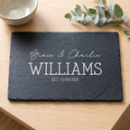 Personalised 30cm x 20cm rectangular slate platter laser engraved in Timeless Classic font layout on dark stone surface.