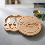 Personalised round swivel cheese board engraved in Bespoke Heirloom font layout on natural rubberwood.