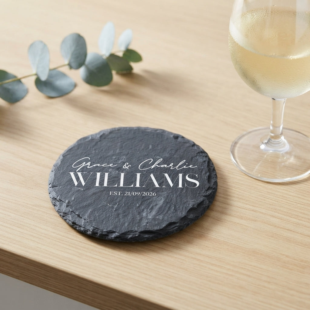 Personalised engraved round slate coaster styled with a drink glass on a timber table in Australia.