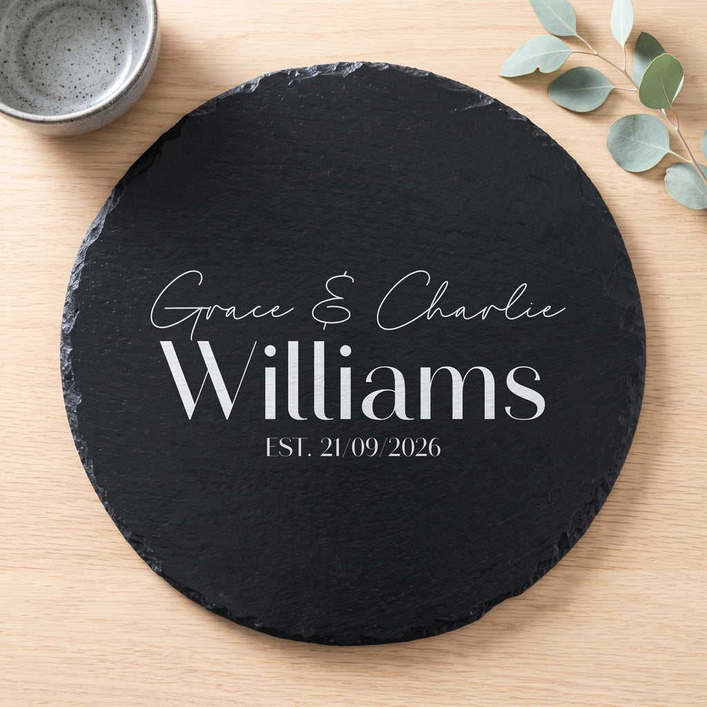 Personalised engraved round slate platter styled with artisanal cheeses and fruit on a wooden table in Australia.