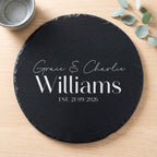 Personalised engraved round slate platter styled with artisanal cheeses and fruit on a wooden table in Australia.