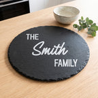 Personalised engraved round slate platter styled with cheeses and fruit on a table in Australia.