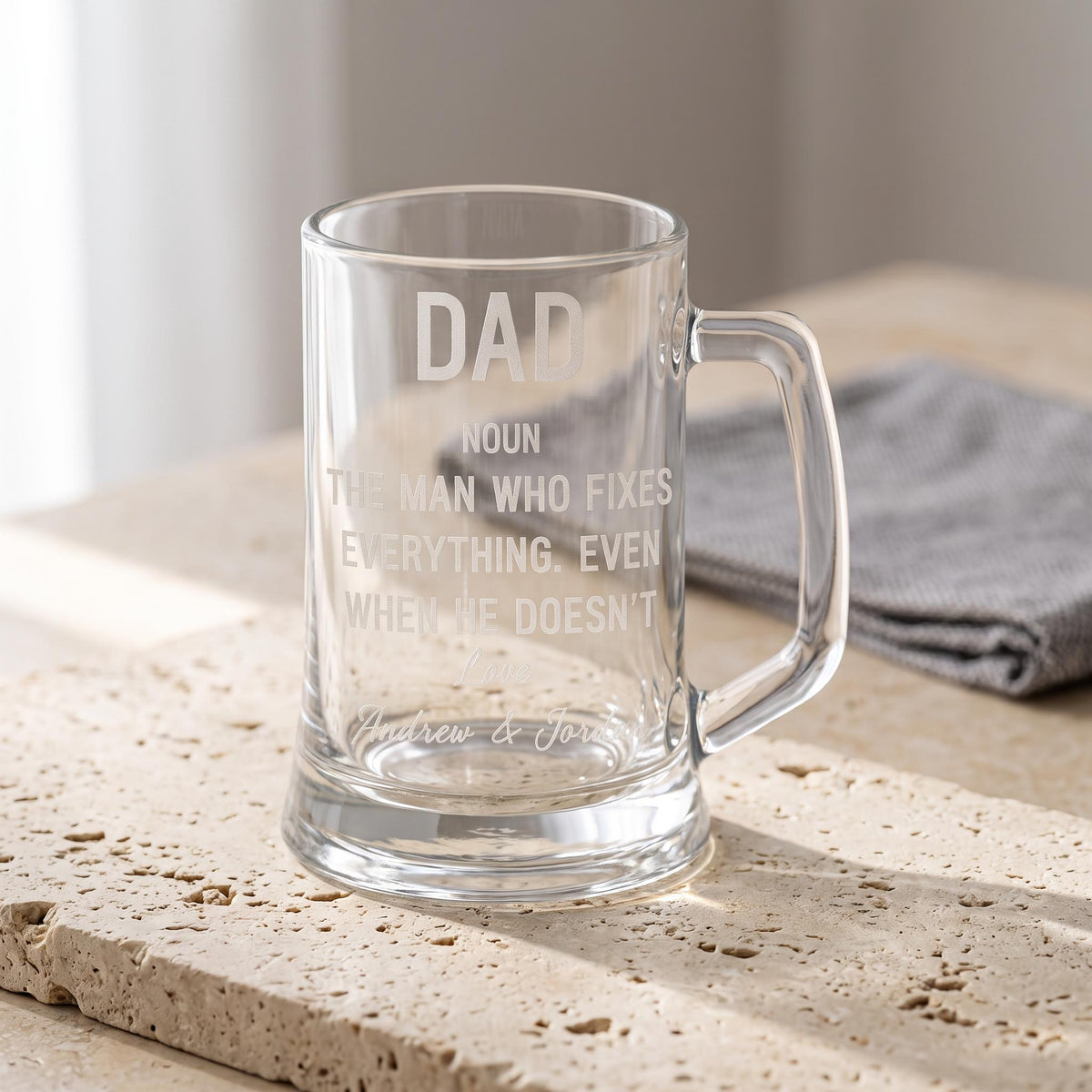 A heavy glass beer mug laser engraved with a custom name and message, handcrafted by Make It Personal Gift Co in Australia.