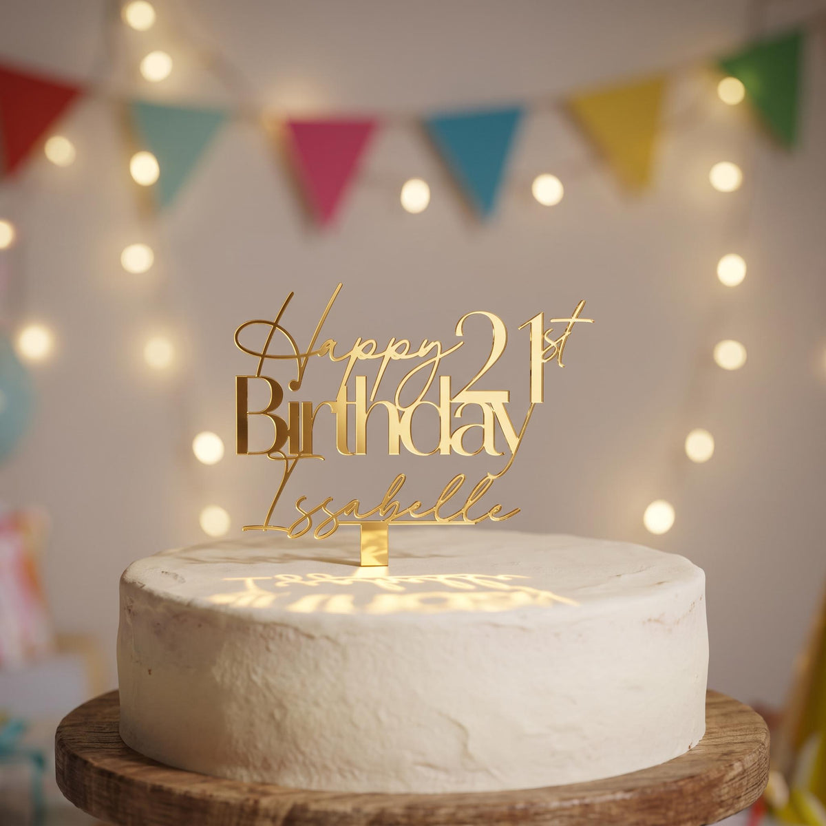 Custom gold mirror acrylic cake topper displaying Happy 21st Birthday Isabelle above a celebration cake.
