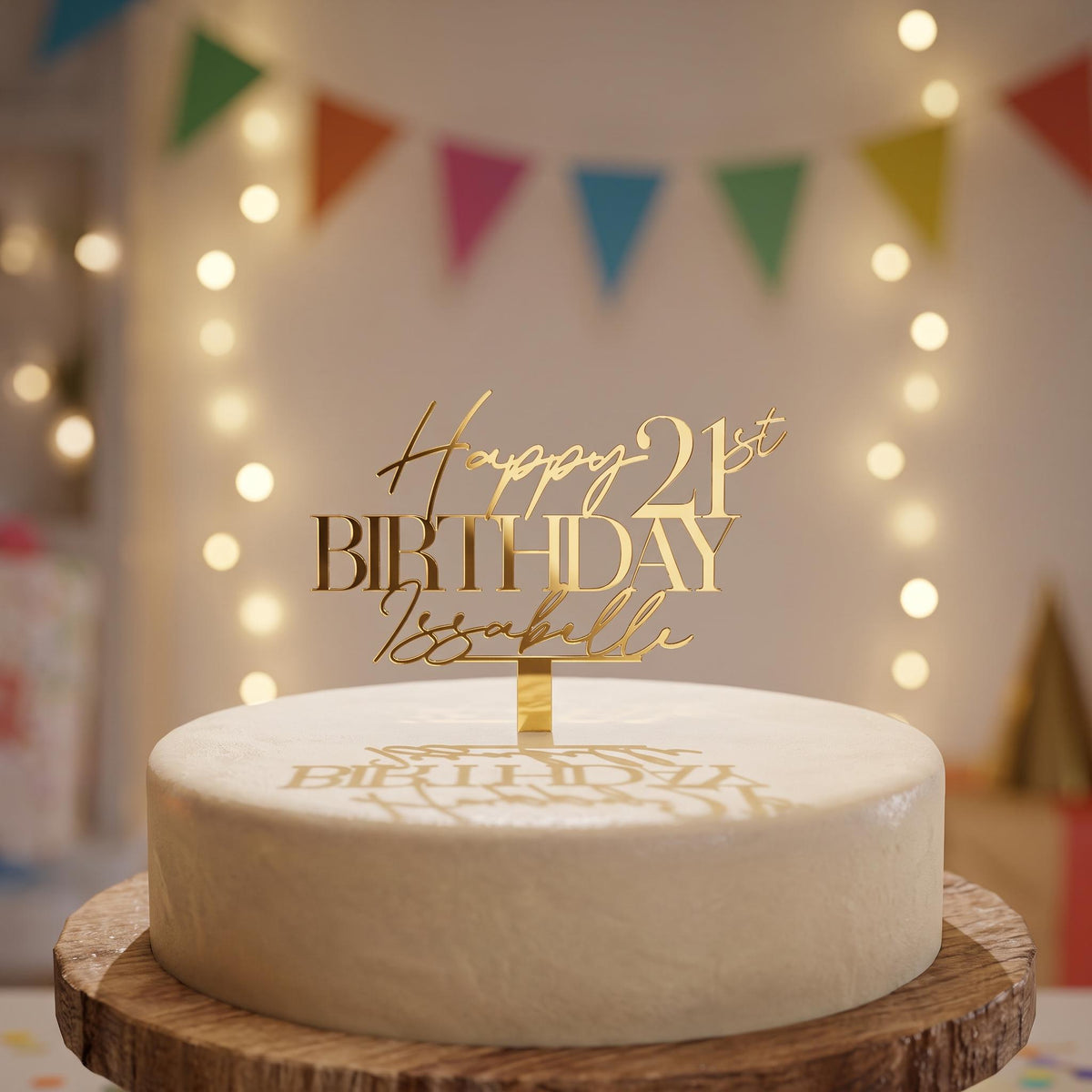 Custom gold mirror acrylic cake topper displaying Happy 21st Birthday Isabelle above a celebration cake.