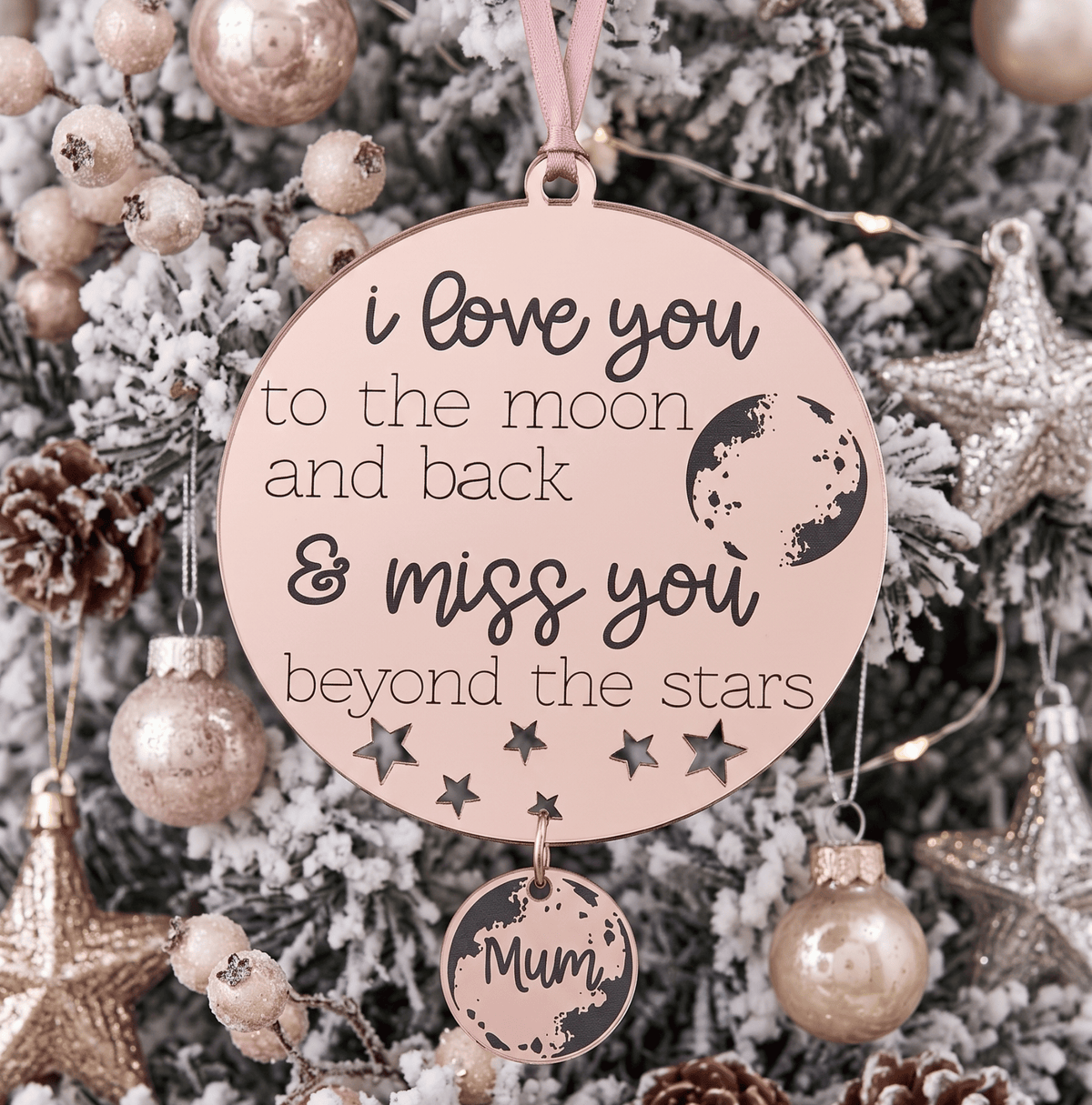 Personalised memorial beyond the stars Christmas ornament made of rose gold mirrored acrylic hanging on a tree