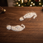 Close up view of reusable timber elf boot print stencil with white powder on timber flooring
